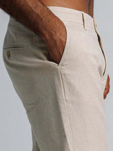 Load image into Gallery viewer, Close-up of linen blend tapered trousers featuring side pockets and a tailored fit.
