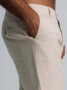 Close-up of linen blend tapered trousers featuring side pockets and a tailored fit.