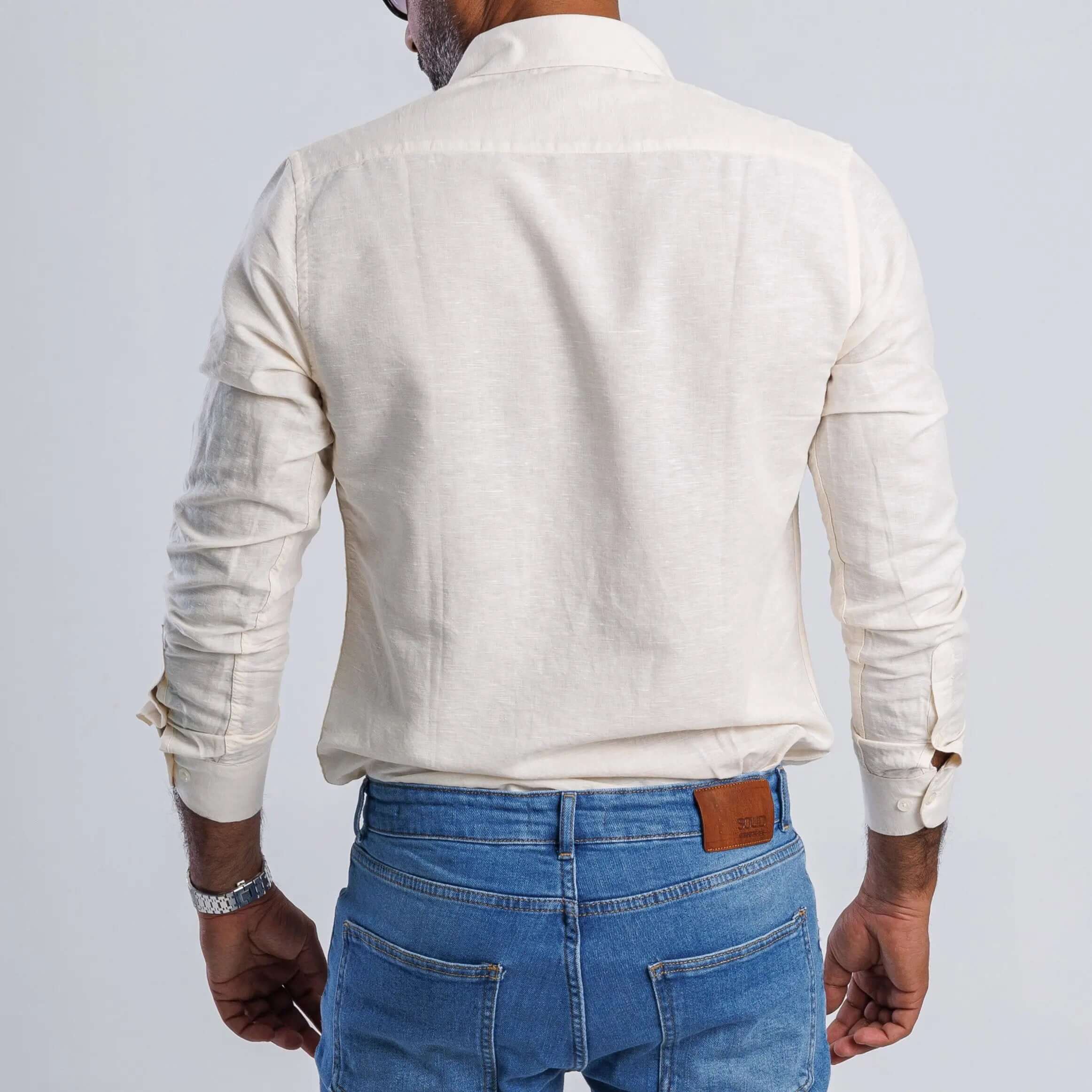 Back view of a man wearing a linen blend slim fit shirt, showcasing its soft and breathable fabric.