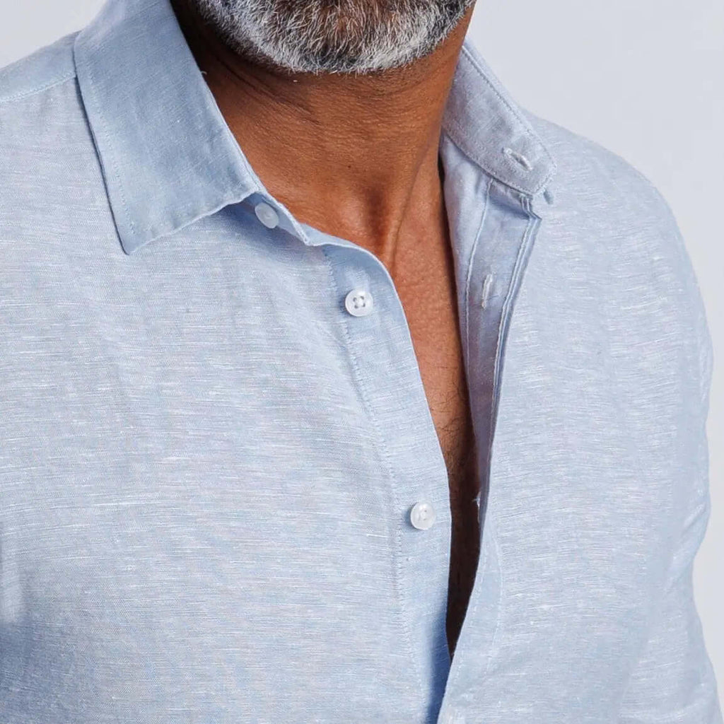Linen blend slim fit shirt in light blue with buttoned collar and cuff, showcasing softness and breathable comfort.