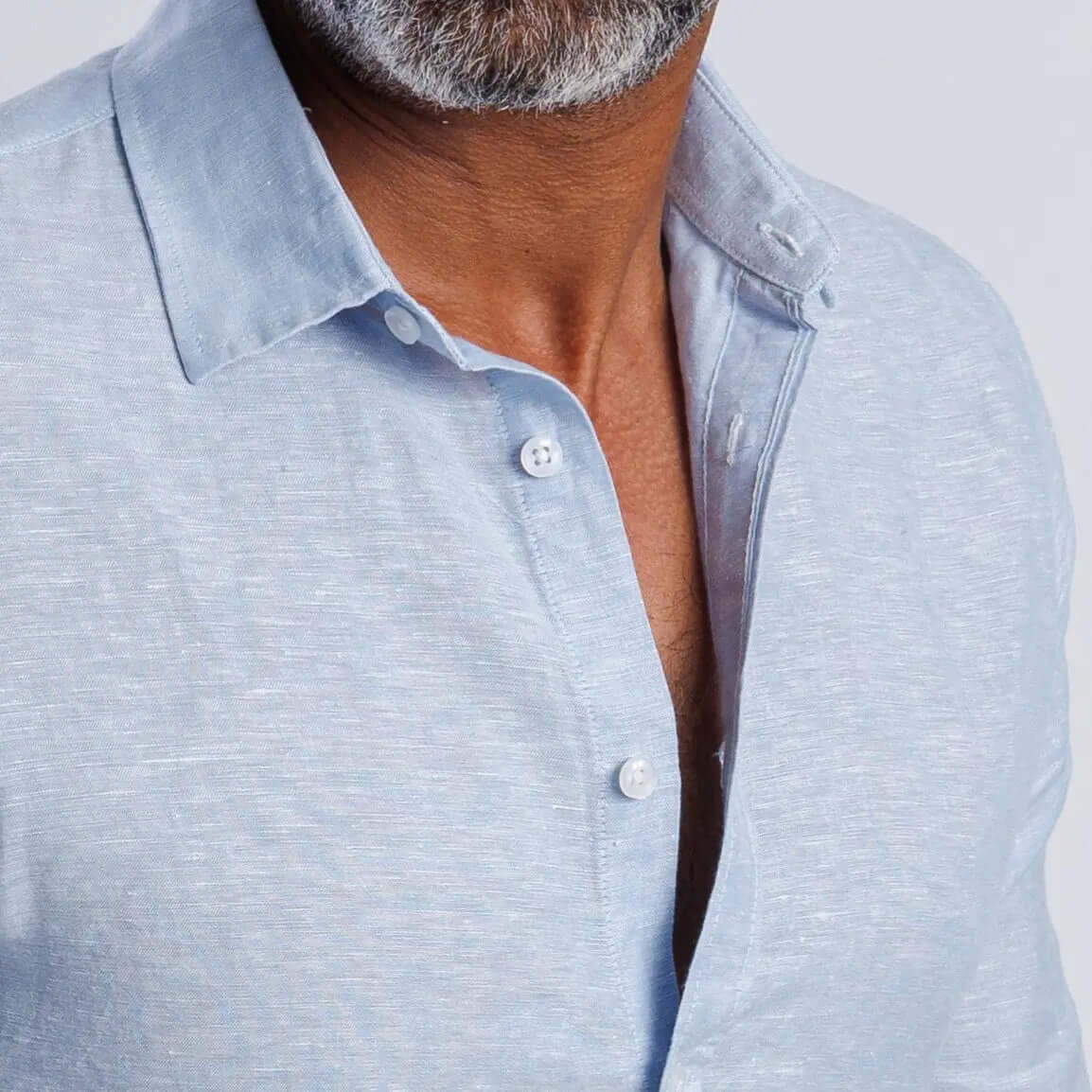 Linen blend slim fit shirt in light blue with buttoned collar and cuff, showcasing softness and breathable comfort.