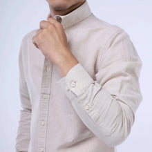 Load image into Gallery viewer, Man showcasing Sahara Breeze™ Linen-Cotton Shirt in Desert Dune color with slim-fit design.
