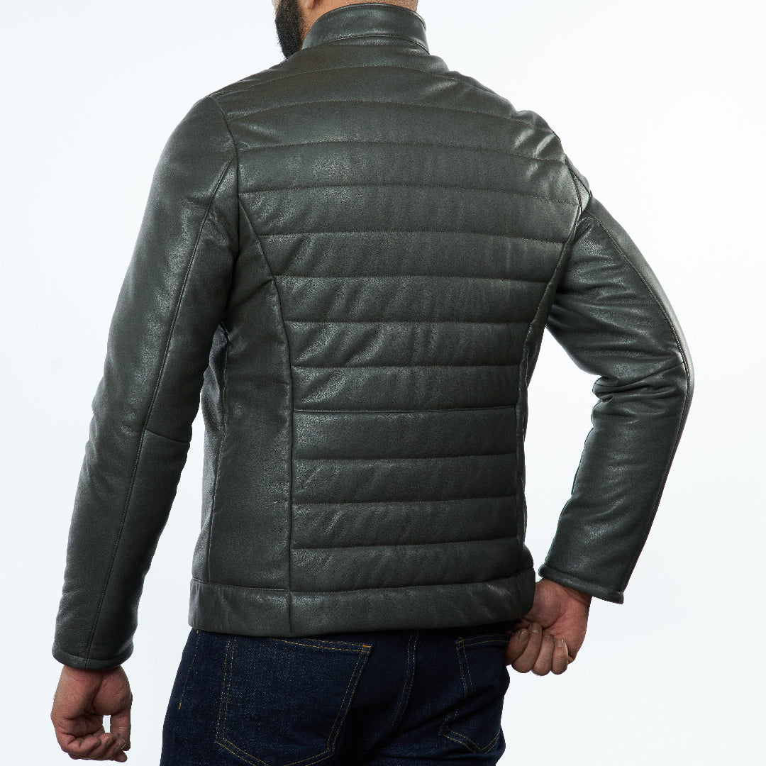 Green leather jacket worn by a person on a white background