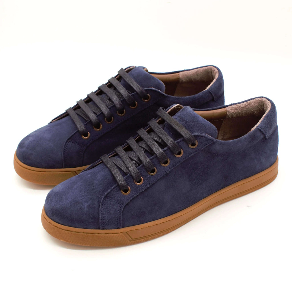 Stylish navy suede low-top sneakers with gum rubber sole and laces, perfect for casual wear.