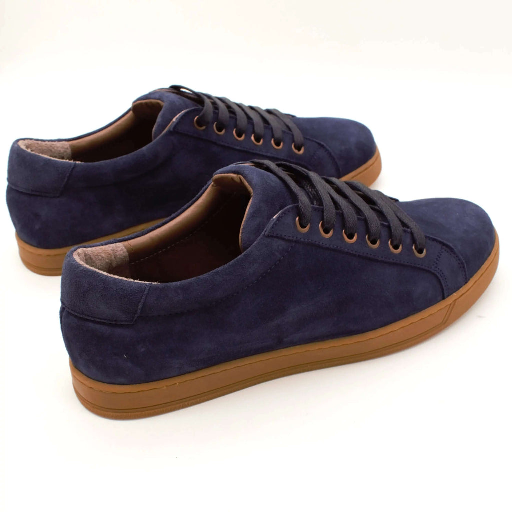 Suede low-top sneakers in navy blue with brown rubber sole, casual footwear for stylish comfort.