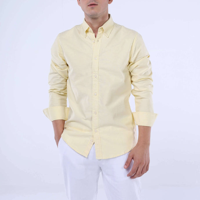 Model wearing a lightweight SummerLite™ Oxford Shirt in yellow, showcasing summer elegance and comfort.