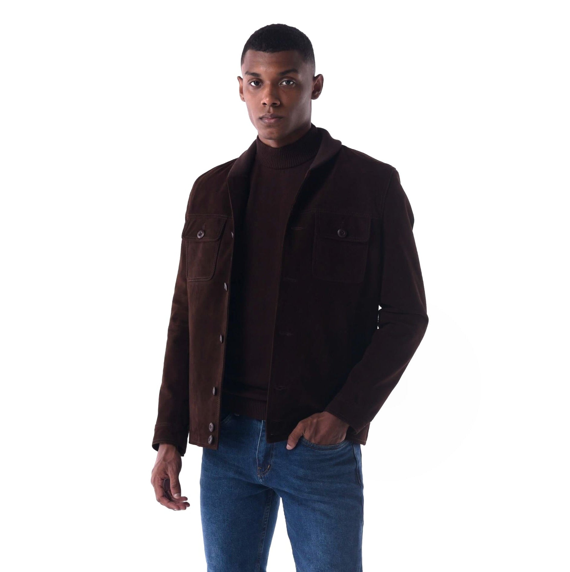 Man wearing a brown jacket over a turtleneck and blue jeans on a white background