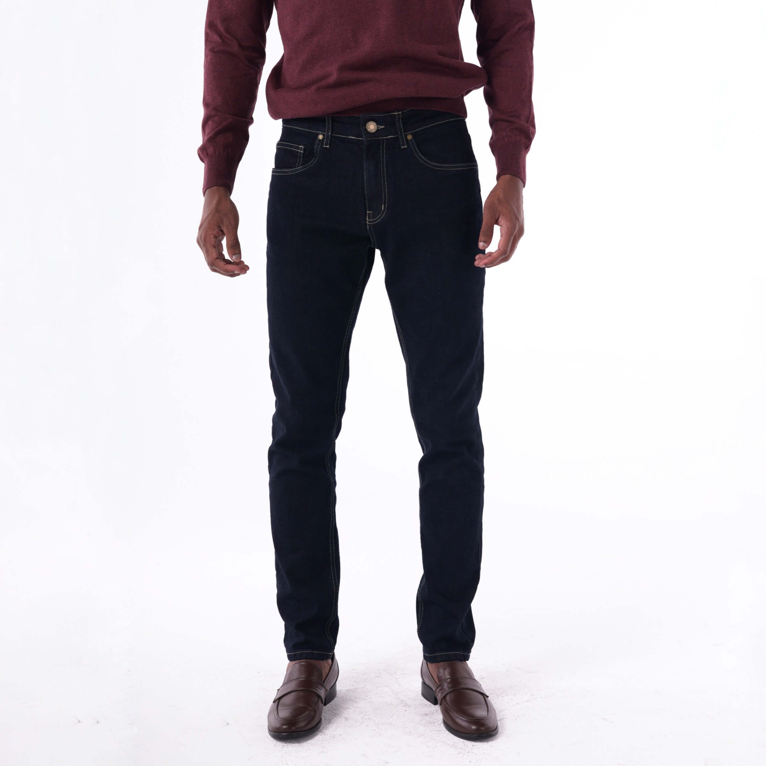 Model wearing SOLID navy slim denim jeans with beige contrast stitching, showcasing a stylish and structured fit.