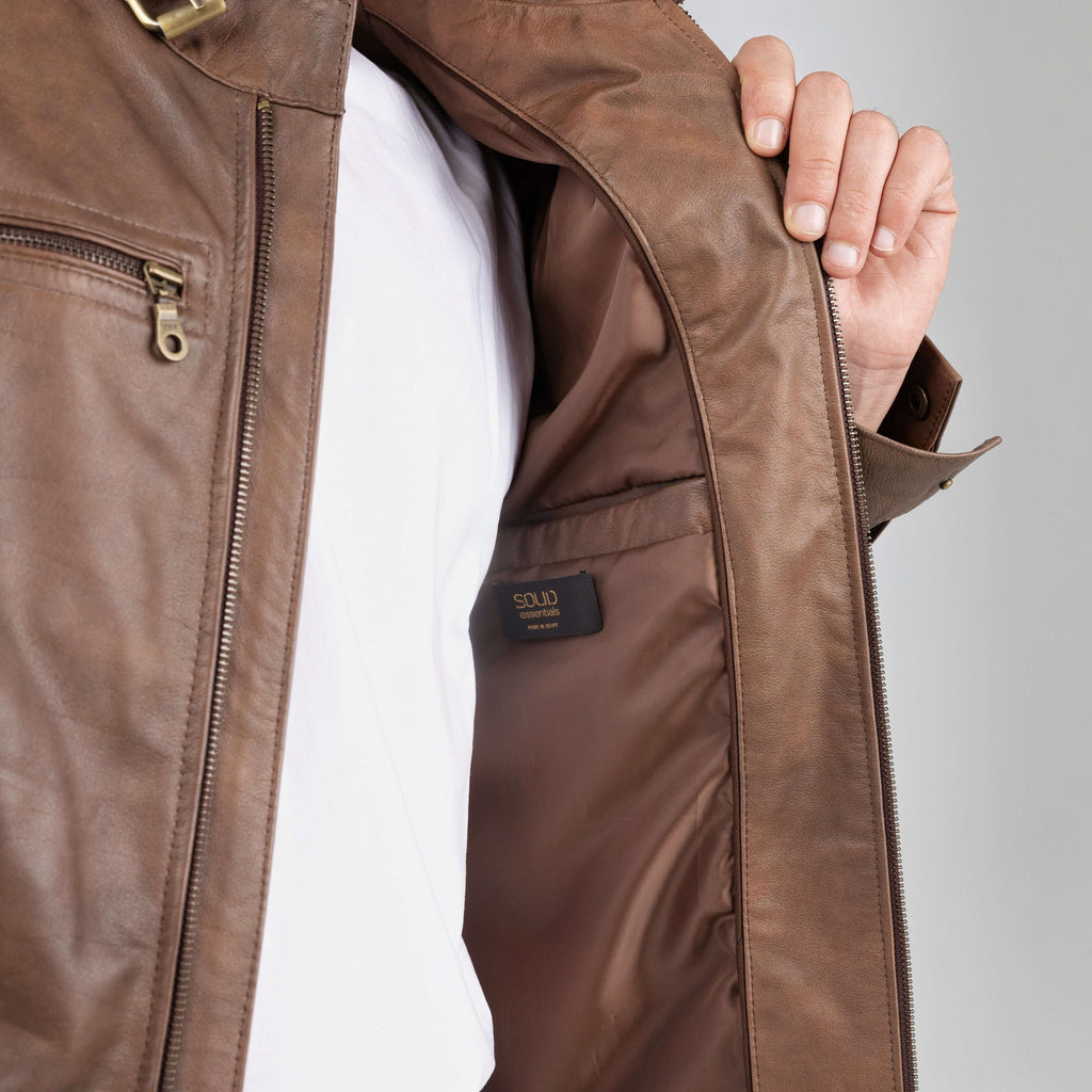 Brown jacket with a brand logo on a gray background