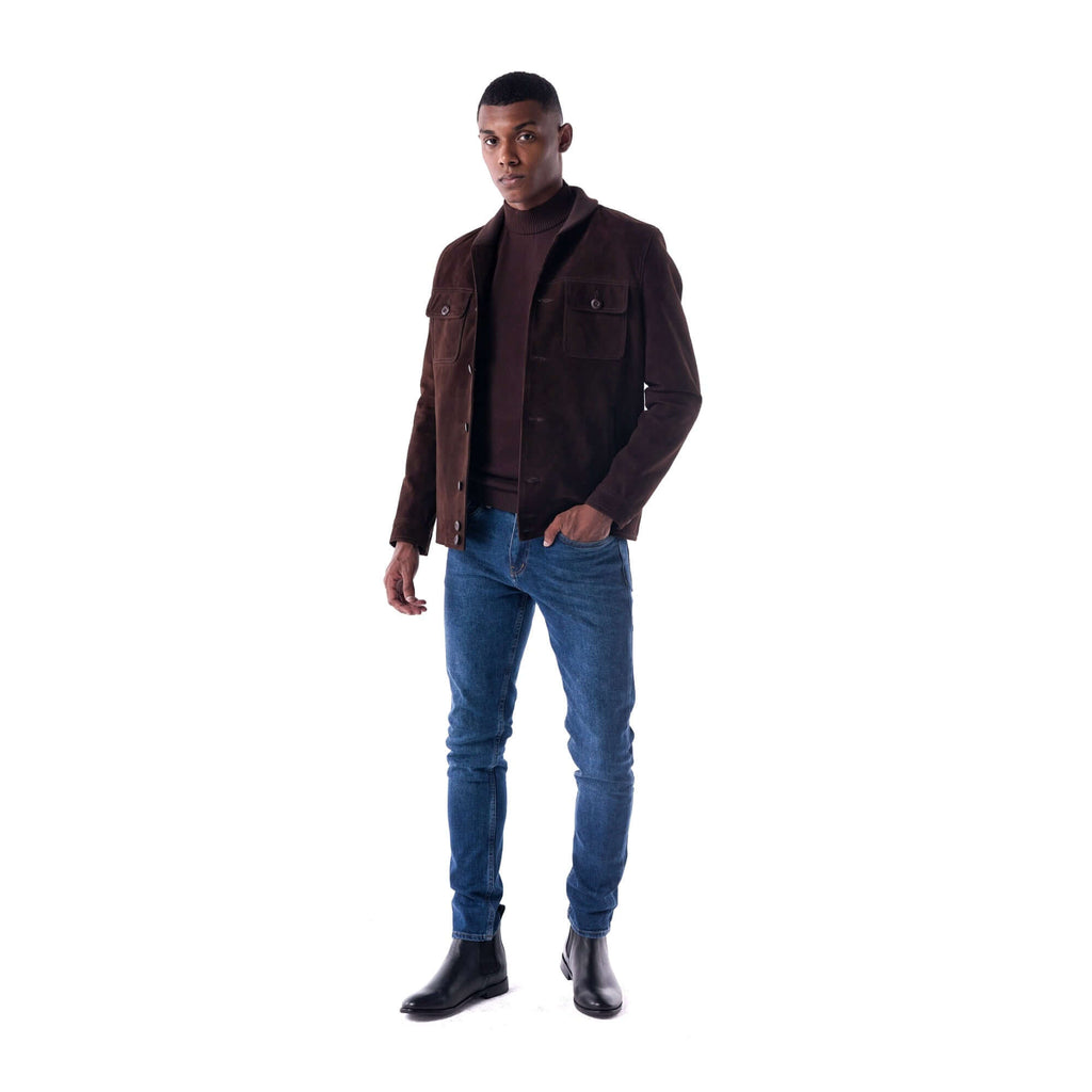 Man wearing a brown jacket and blue jeans on a white background
