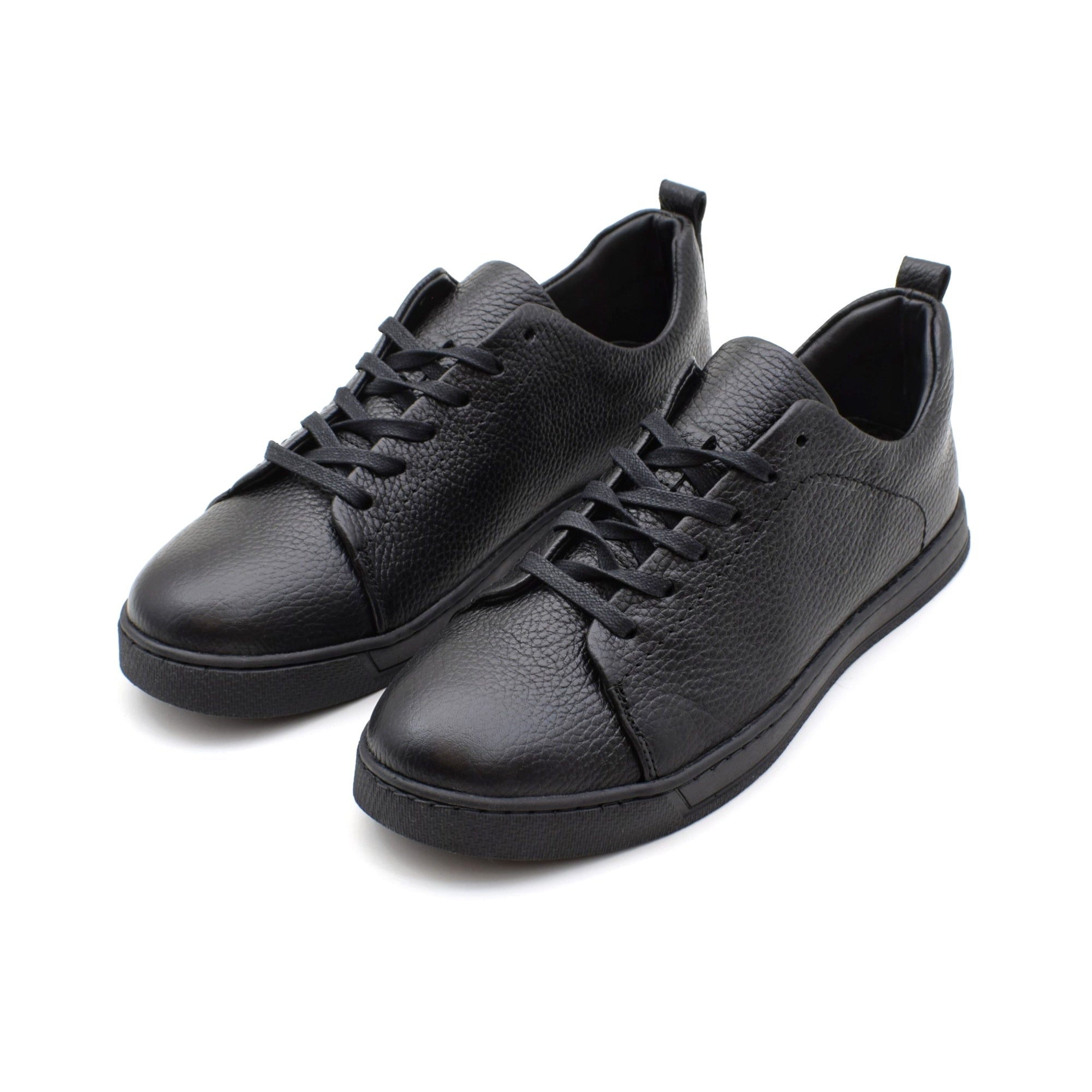 Pair of black leather sneakers on a white background