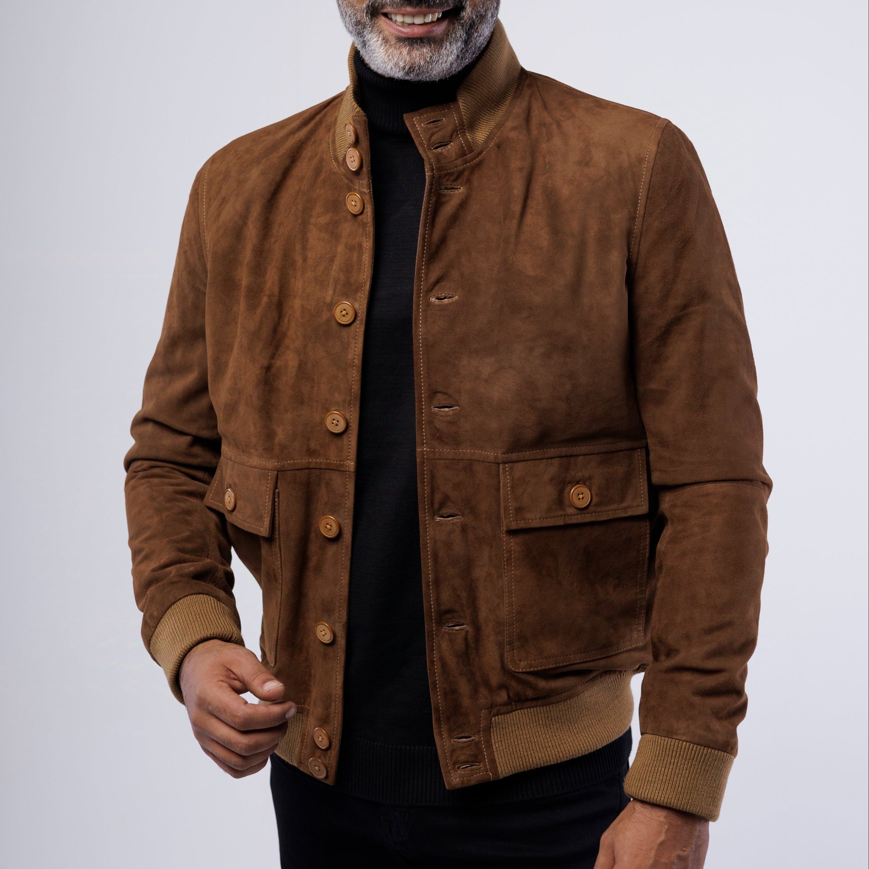 Man wearing a brown suede jacket on a white background
